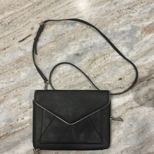 Rebecca Minkoff black leather crossbody. Front pocket under the flap.